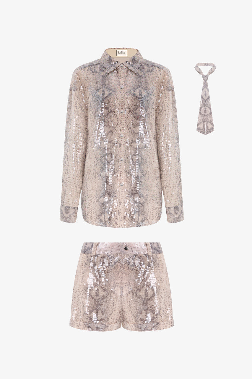 A sequin oversized shirt paired with snakeskin beige shorts.