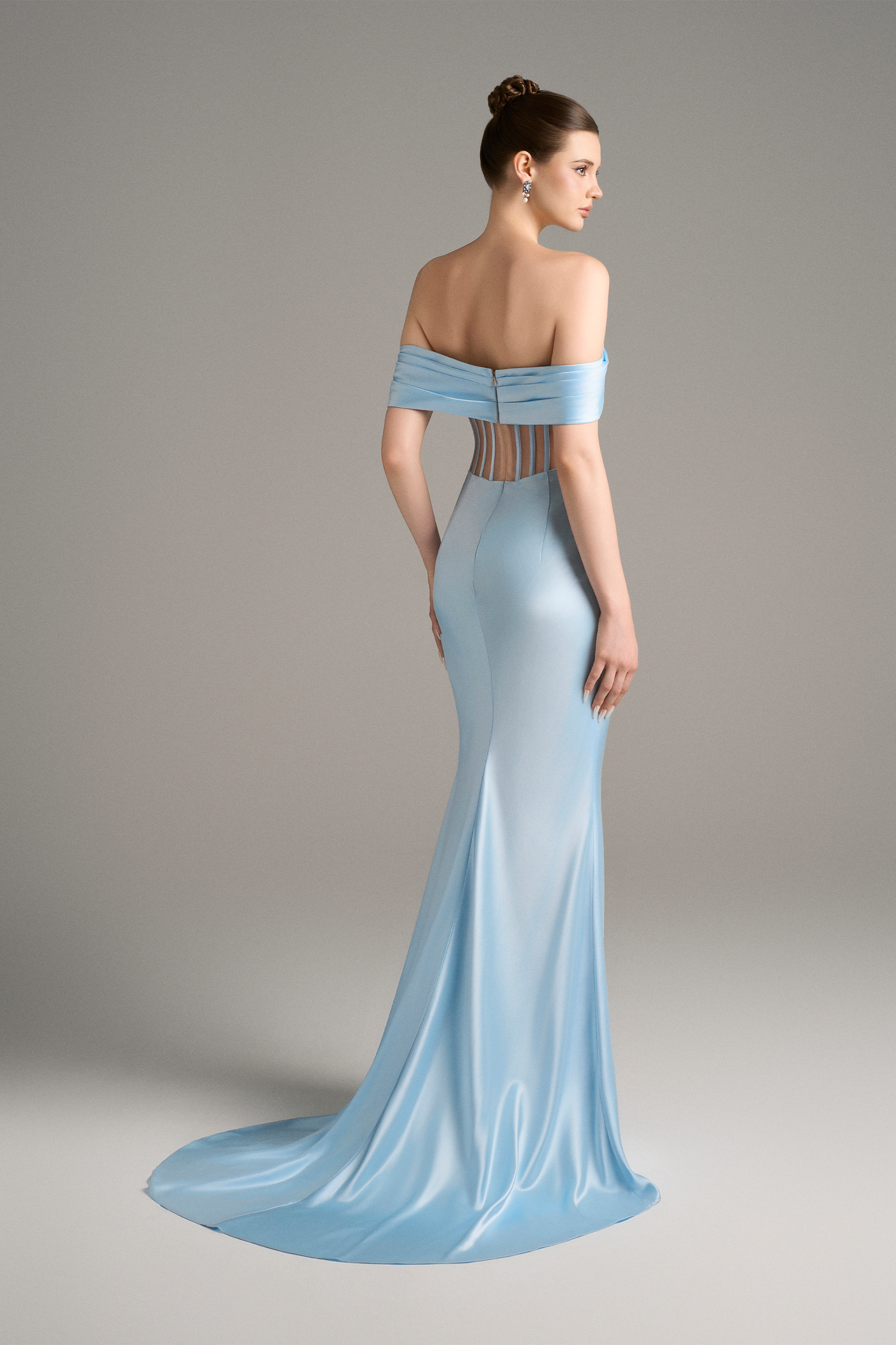 Side view showcasing the sculptural draping and graceful slit of the sky-blue off-shoulder corset gown.