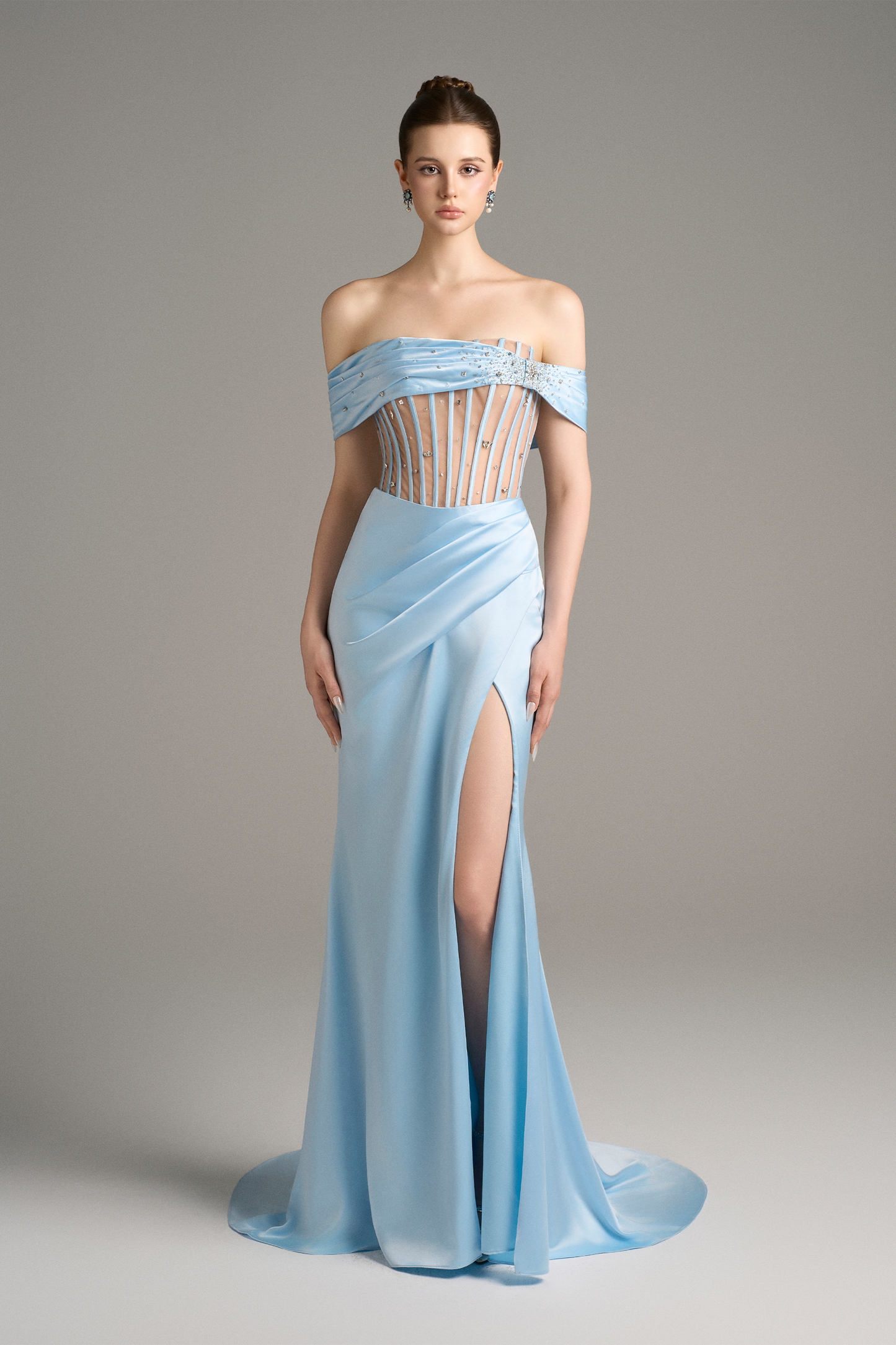 Angled front view capturing the modern sensuality of the sky-blue off-shoulder corset gown with thigh-high slit.