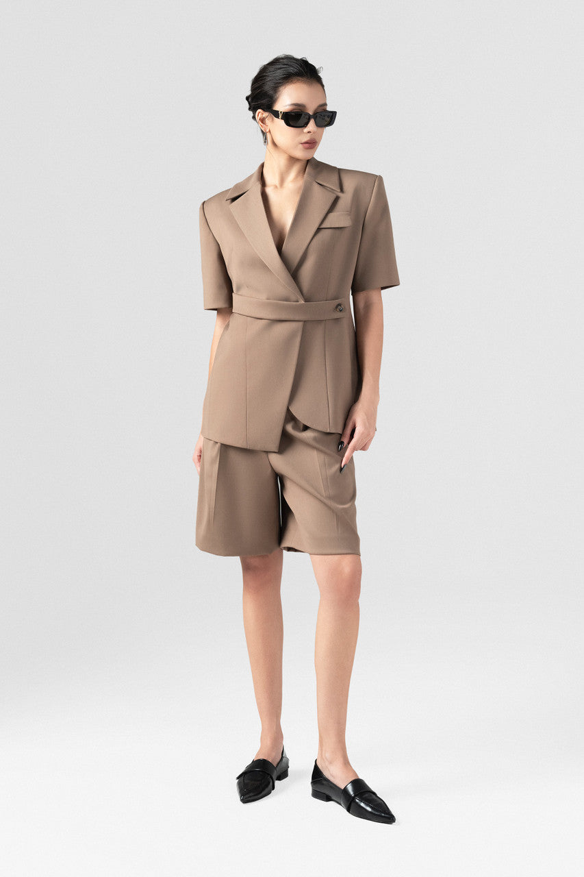 The short-sleeve brown blazer with wide padded shoulders and short menswear with chic waistband detail.