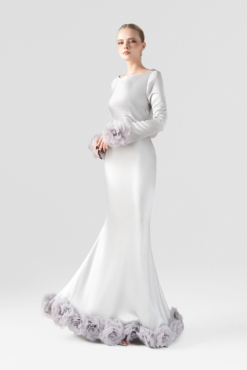 The grey silk maxi dress with mermaid silhouette, plunging open back, and handcrafted floral details at the hem and cuffs.
