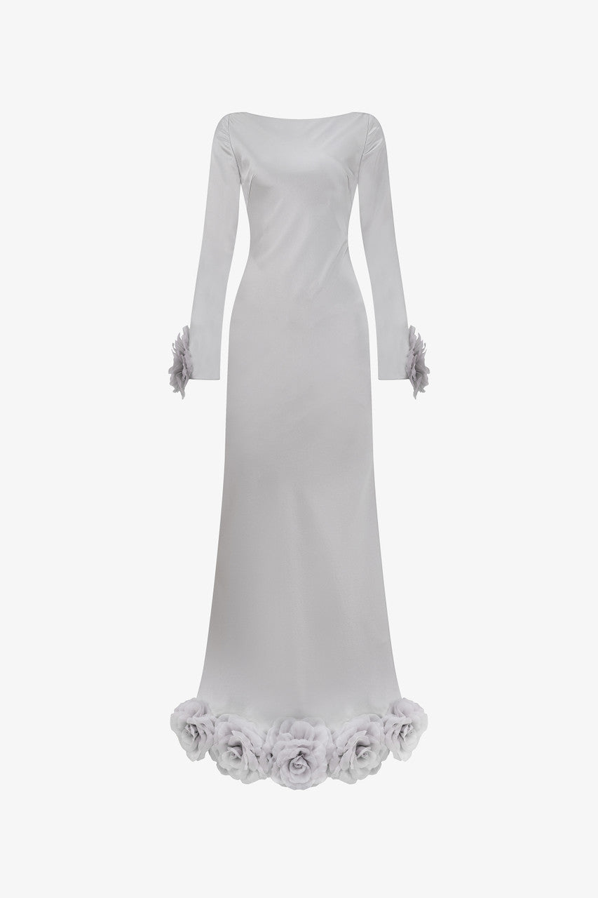 The grey silk maxi dress with mermaid silhouette, plunging open back, and handcrafted floral details at the hem and cuffs.