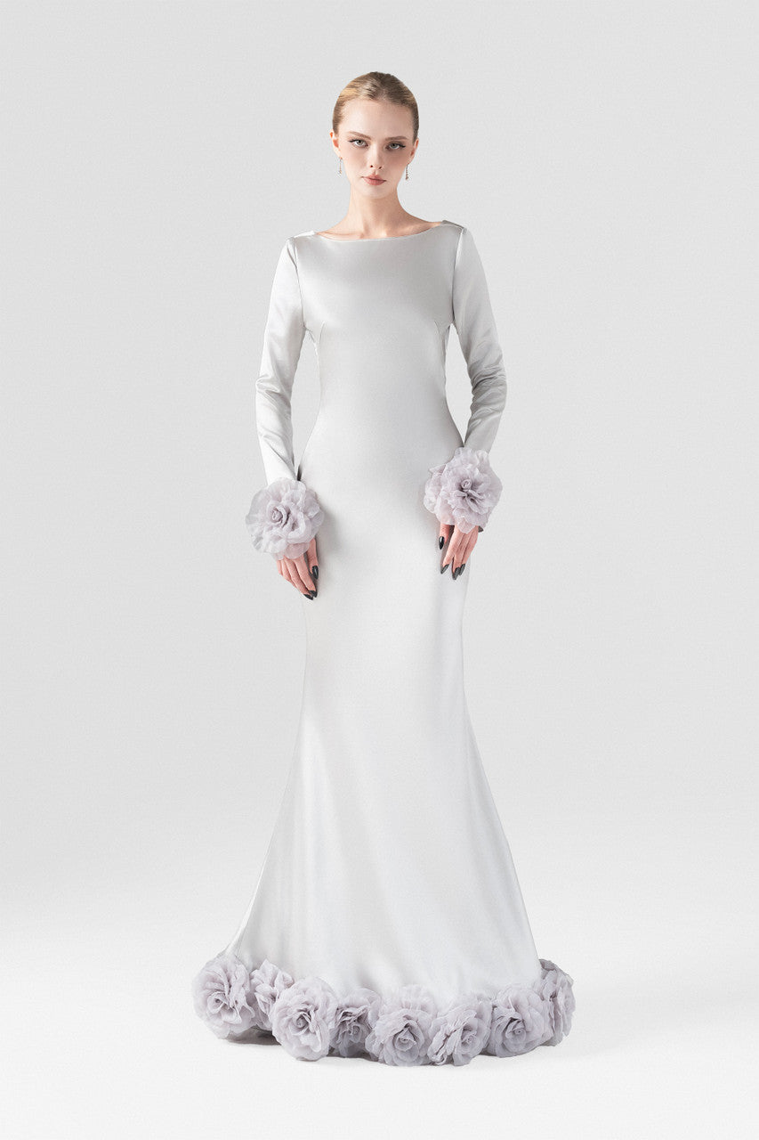 The grey silk maxi dress with mermaid silhouette, plunging open back, and handcrafted floral details at the hem and cuffs.