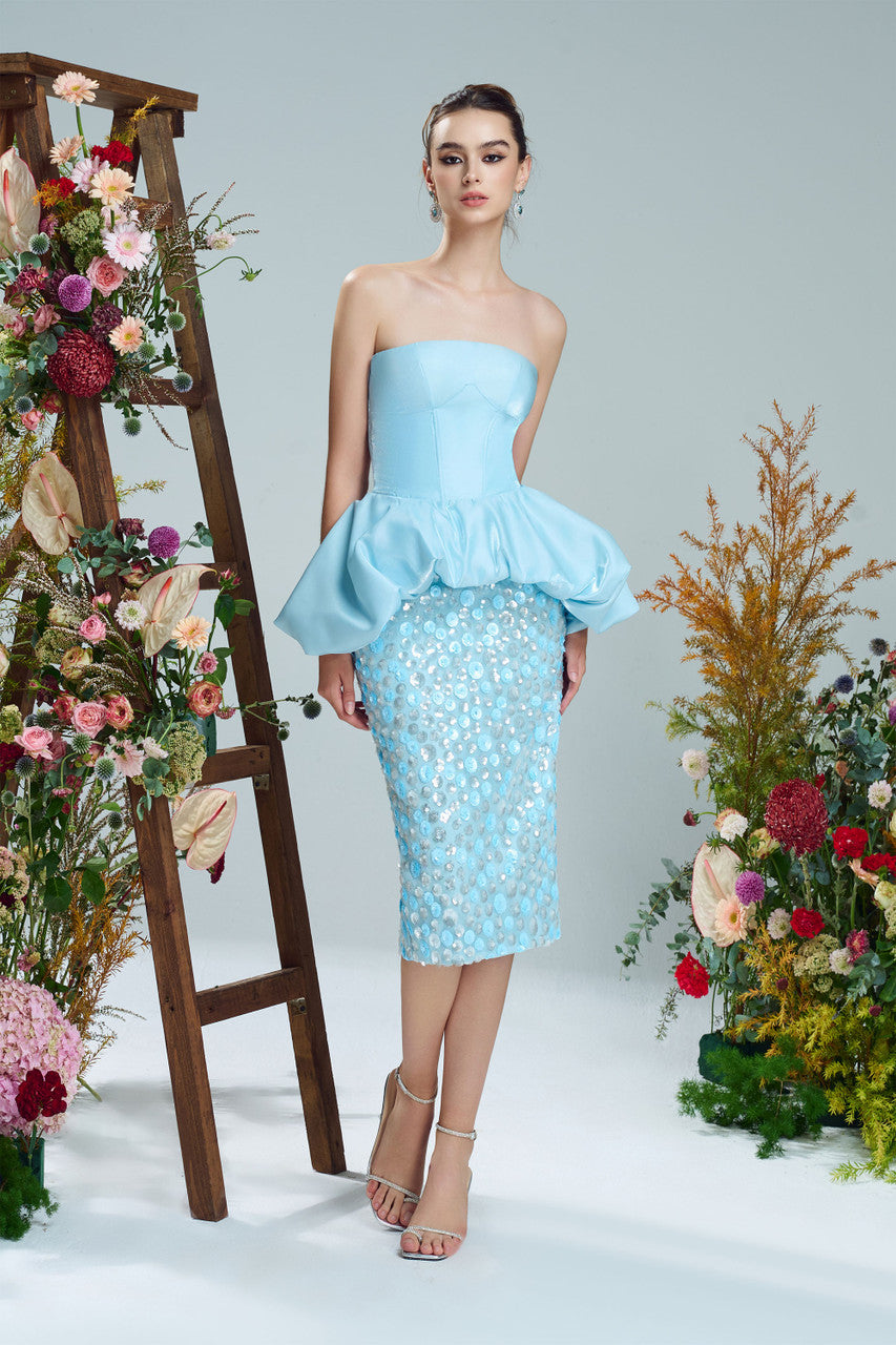 A blue sequin dress with corset bodice, peplum design and sparkling silver embellishments.