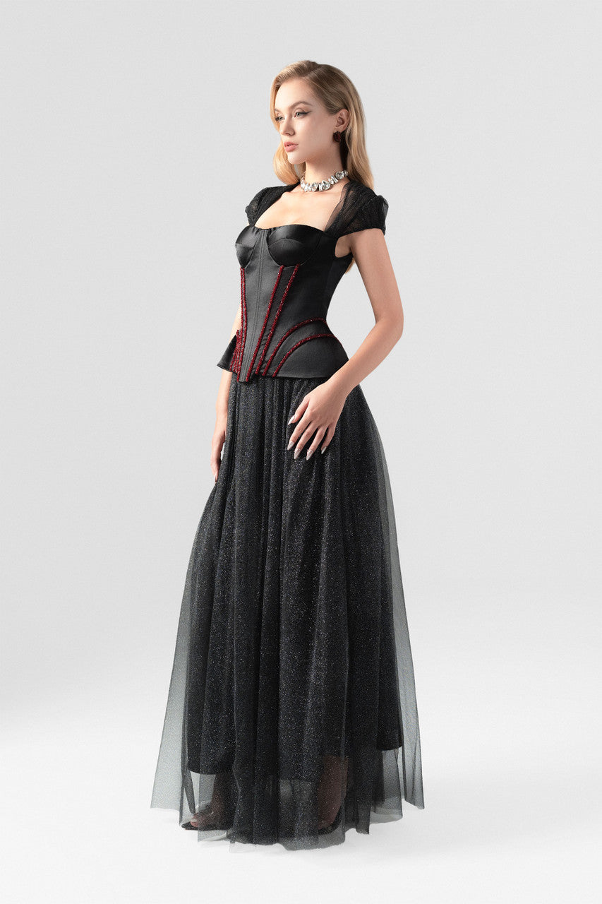 A black evening dress in sequin and taffeta, embellished with a rhinestone row at the waist.