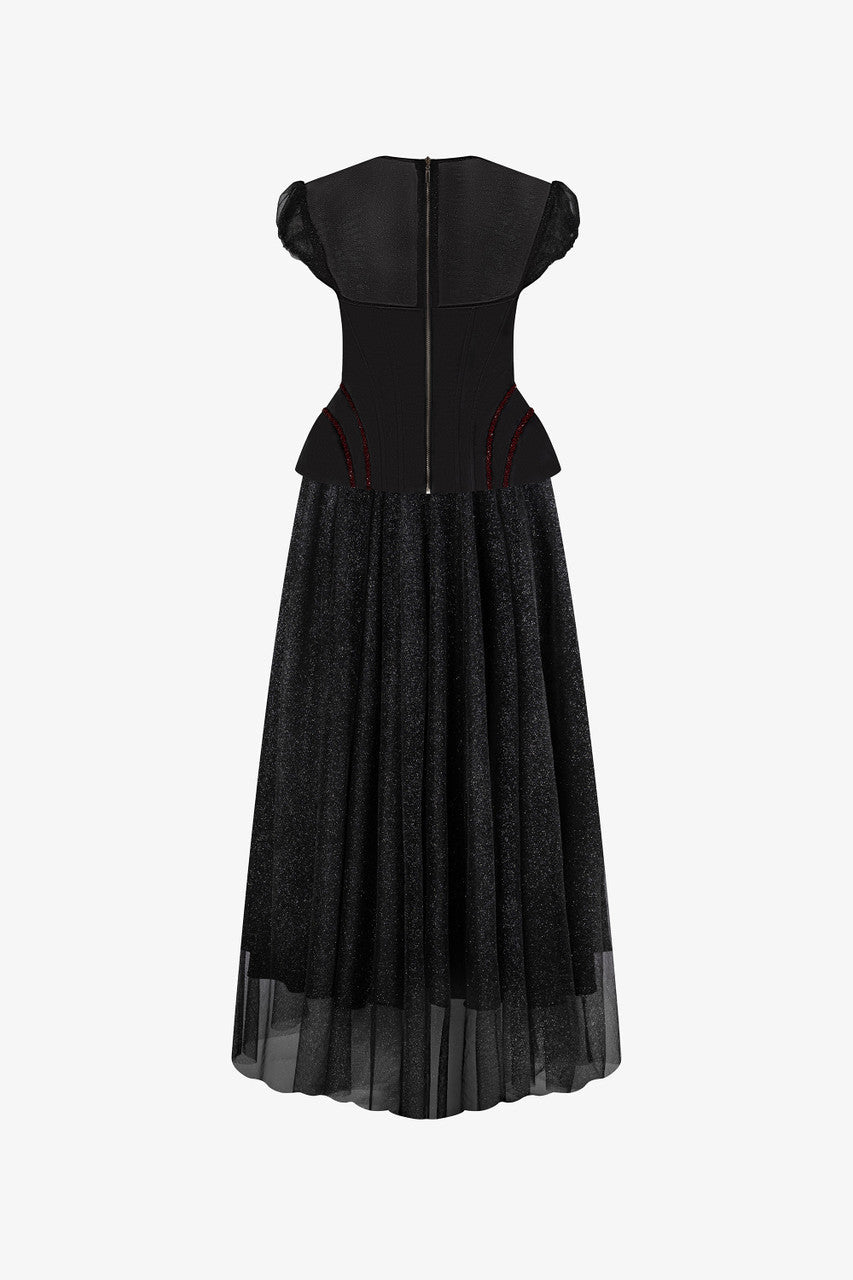 The back of this black dress features a structured corset-style bodice with a layered sheer skirt.