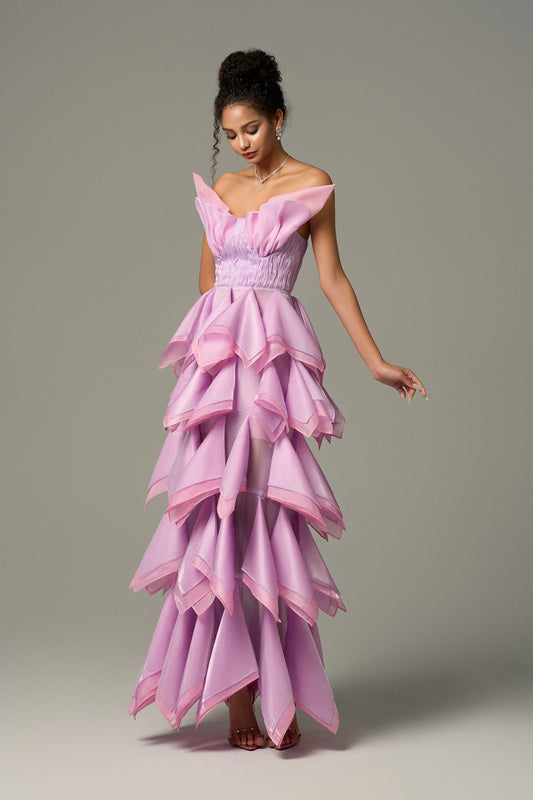 Strapless maxi dress features a sculpted bodice that hugs the waist and a flowing, layered skirt.