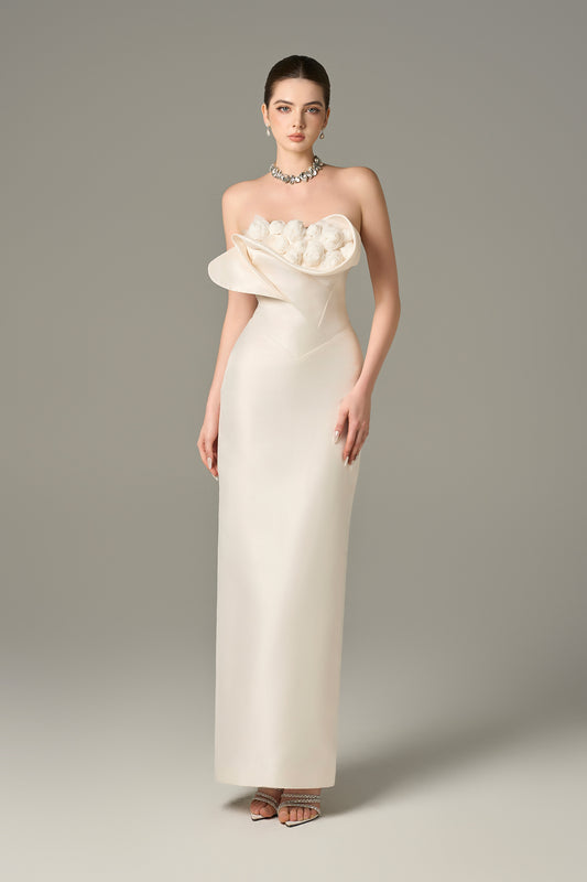 The White Floral Embellished Maxi Dress with a strapless bodice and delicate hand-sewn floral details.