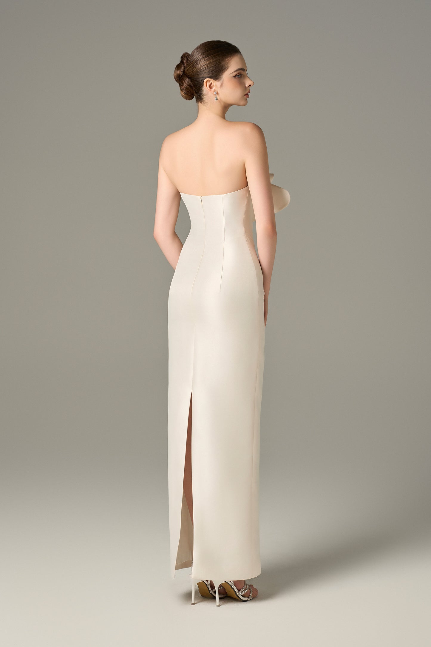 The back of the White Floral Embellished Maxi Dress has a delicate slit.