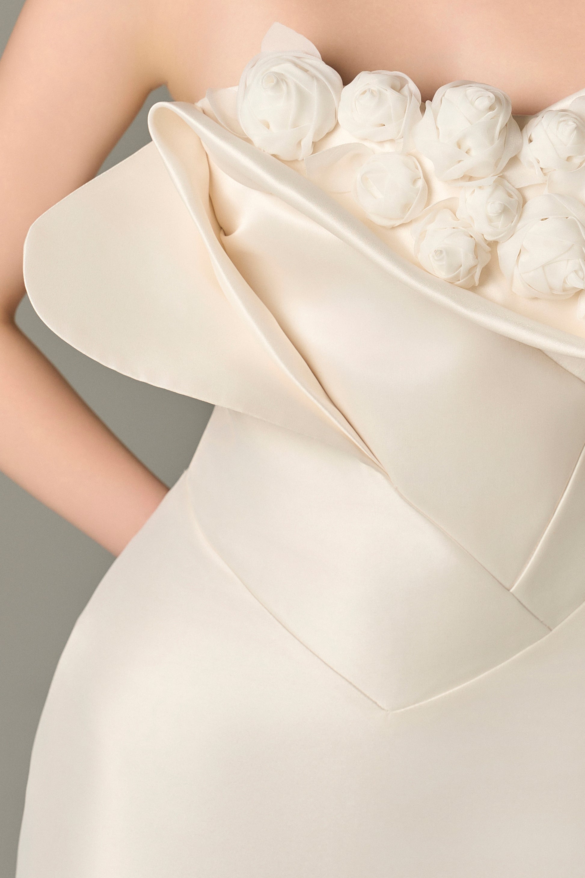 The White Floral Embellished Maxi Dress with a strapless bodice and delicate hand-sewn floral details.