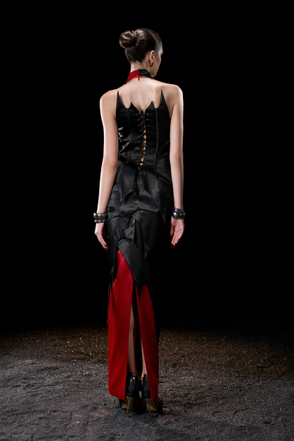Woman wearing a black and red dress with a high slit