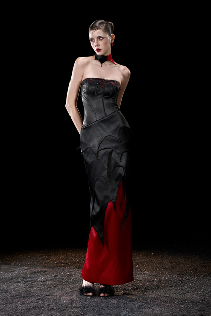 Model wearing a black and red strapless gown