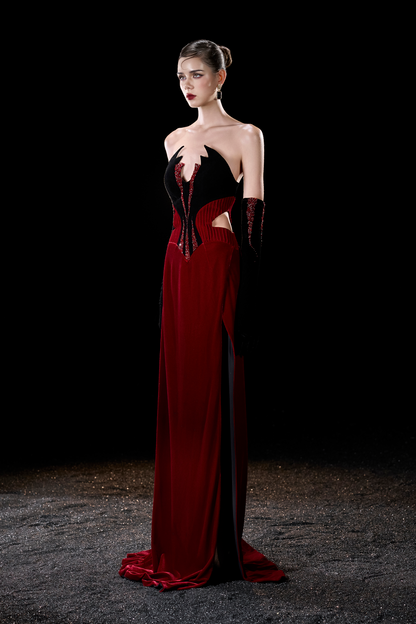 Woman wearing a black and red evening gown with cut-out design