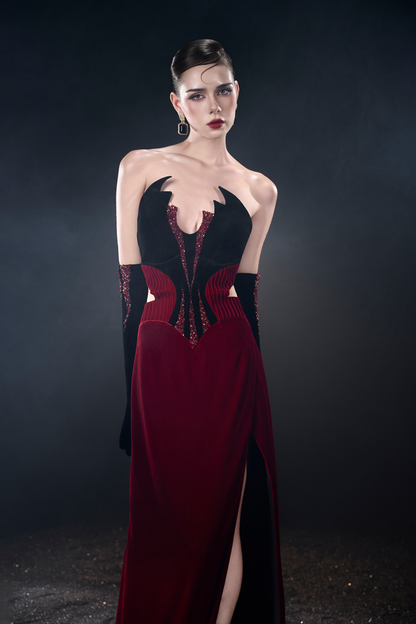 Model wearing a black and red evening gown