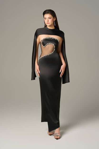 The Black Front Cut Out Gown features a daring cut-out with shimmering stone details.