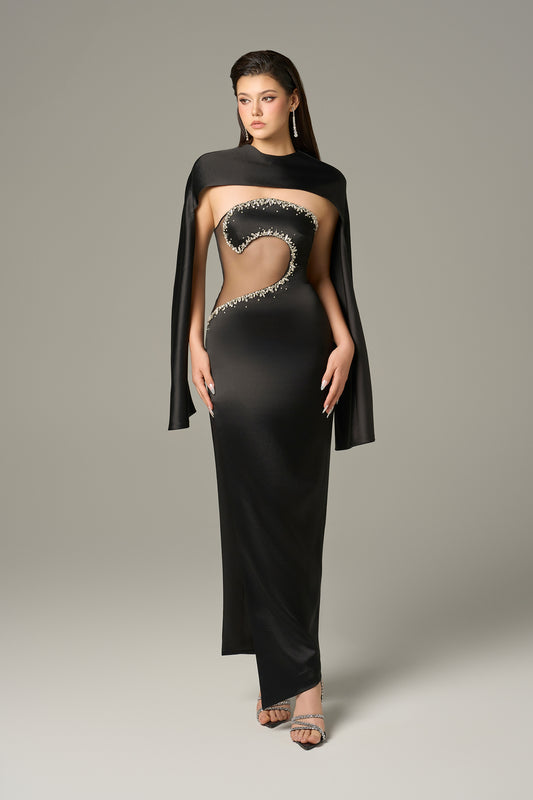 The Black Front Cut Out Gown features a daring cut-out with shimmering stone details.