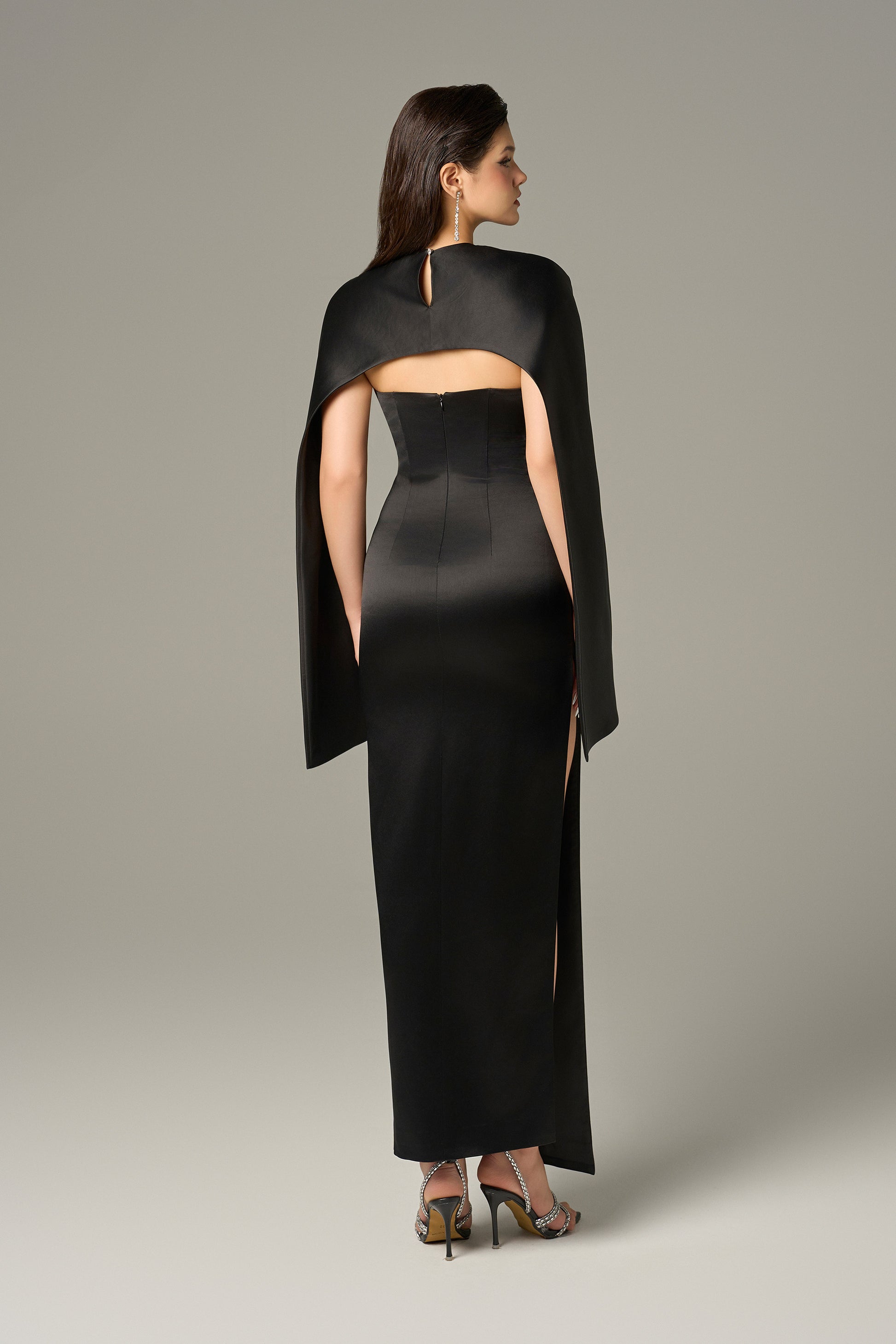 Black maxi gown hugging the waist. 