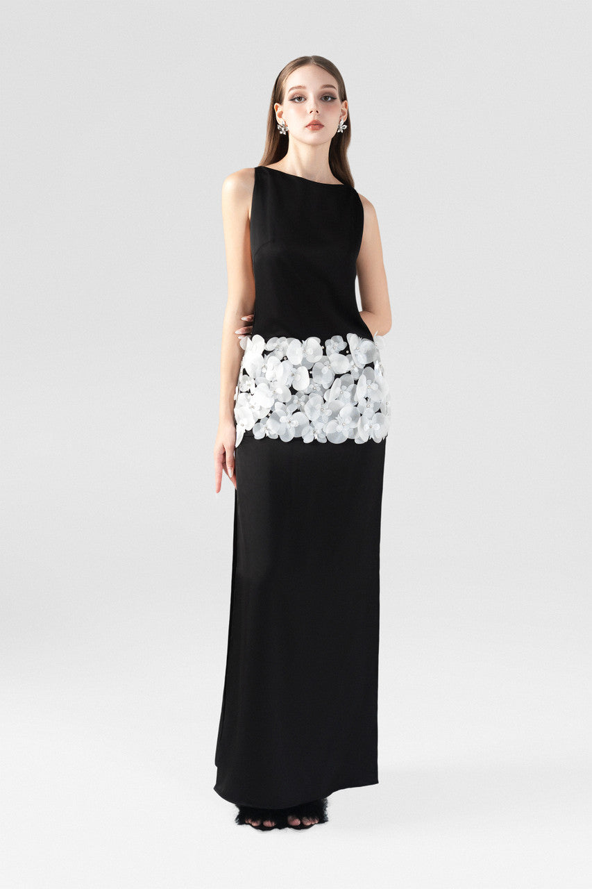 The  black silk dress with boat neckline, thigh-high slits, and handcrafted orchids. 