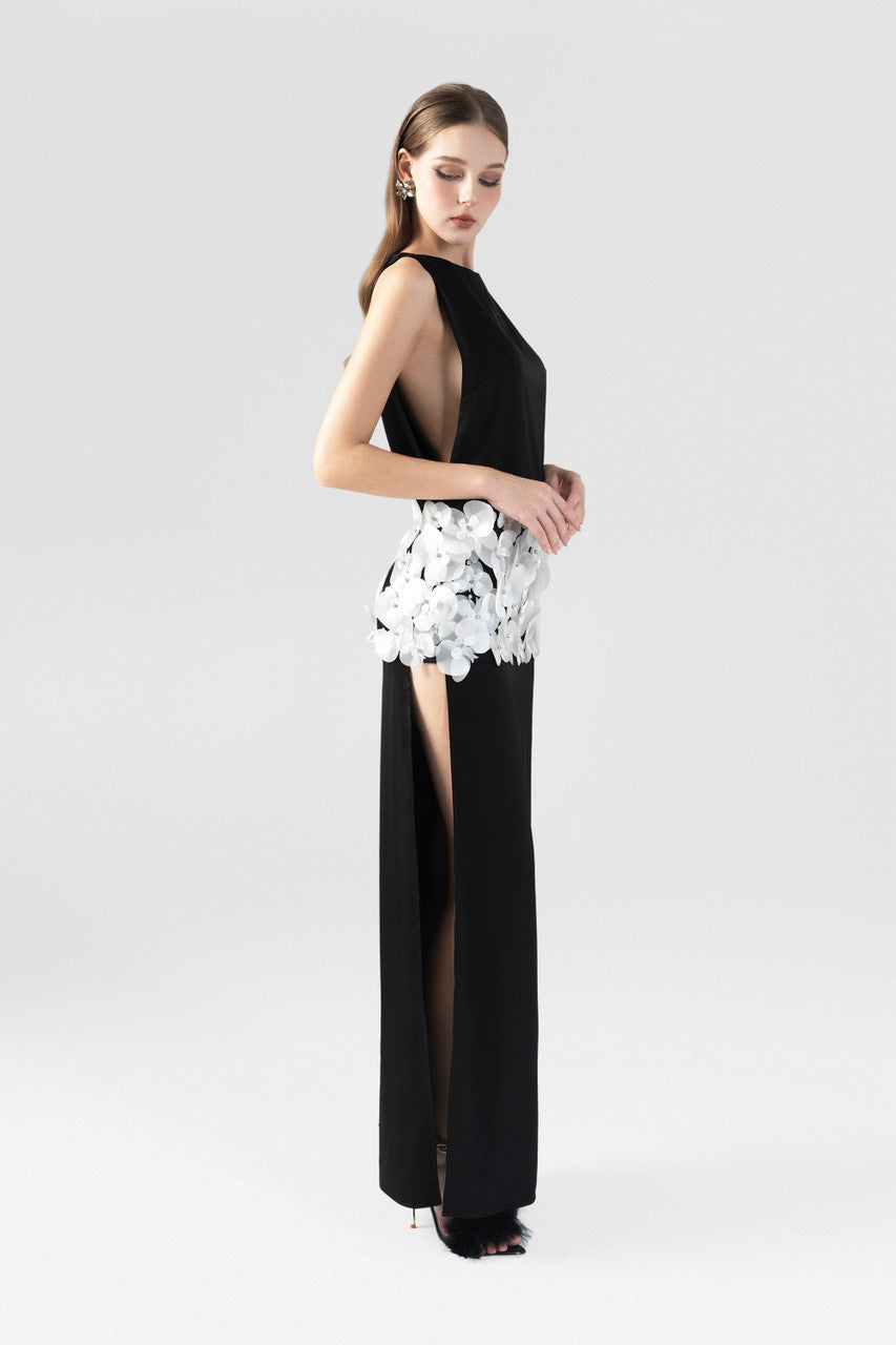The  black silk dress with boat neckline, thigh-high slits, and handcrafted orchids. 