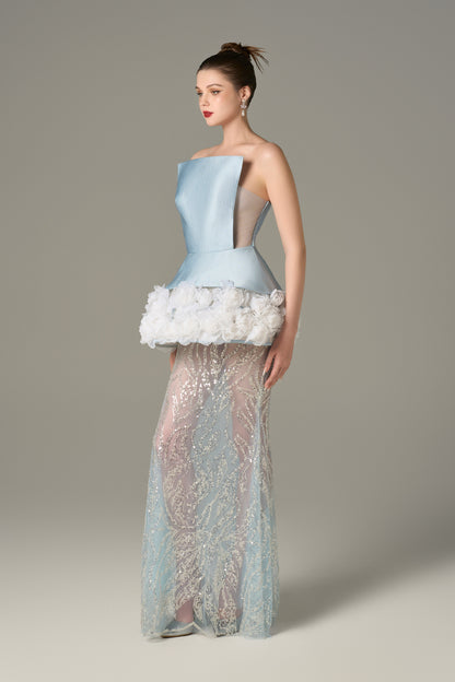 The Blue Gown stuns with a strapless bodice and shimmering lace skirt and handcrafted floral appliqués.