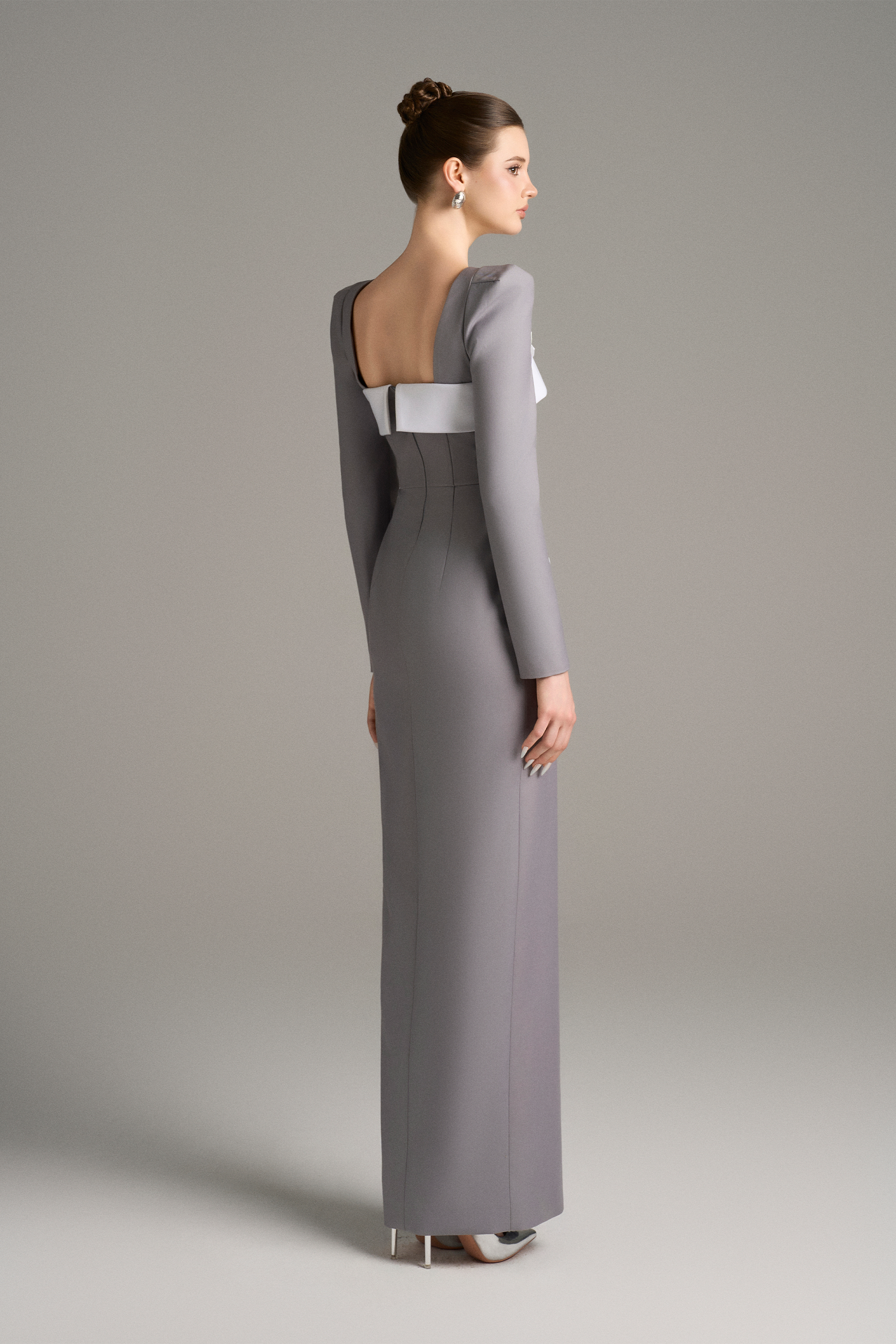 Woman wearing a gray evening gown with a white bodice 