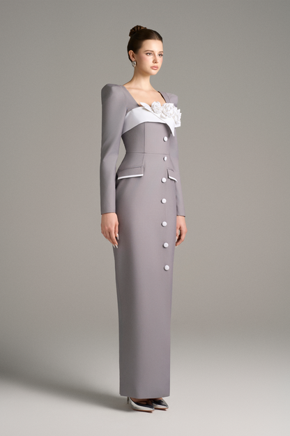 Woman wearing a gray dress with a white floral detail 