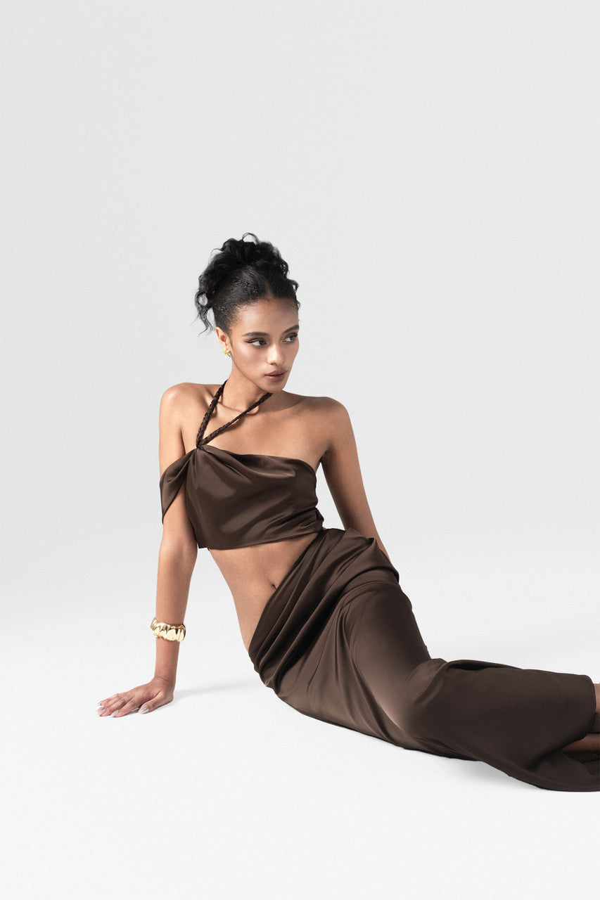 Brown maxi dress in premium silk, crafted with side cutouts, high side slit, and handwoven neck strap.