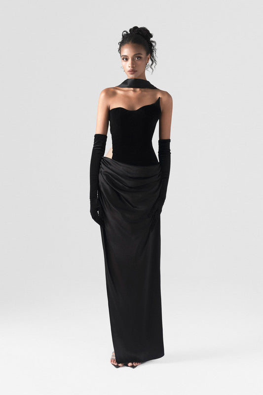 The black maxi dress, combining two premium fabrics: velvet and silk, featuring a matching silk scarf and gloves. 