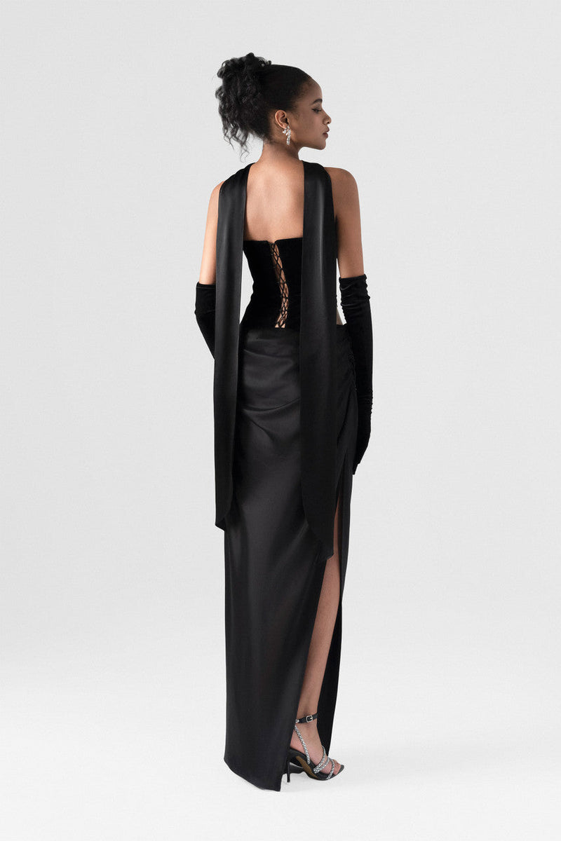The black maxi dress, combining two premium fabrics: velvet and silk, featuring a matching silk scarf and gloves. 