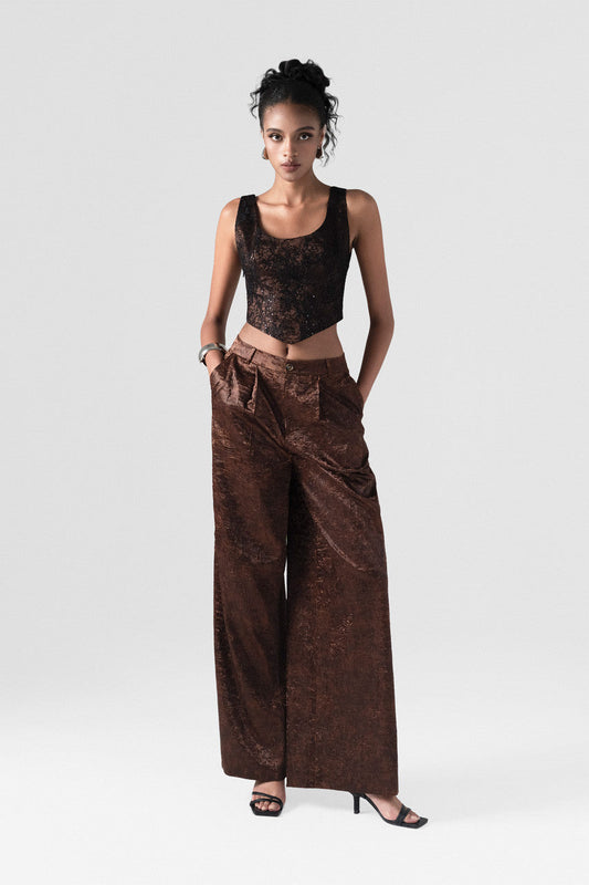 The brown set in satin, featuring a fitted corset crop top with a lace-up back and high-waisted, wide-leg trousers. 
