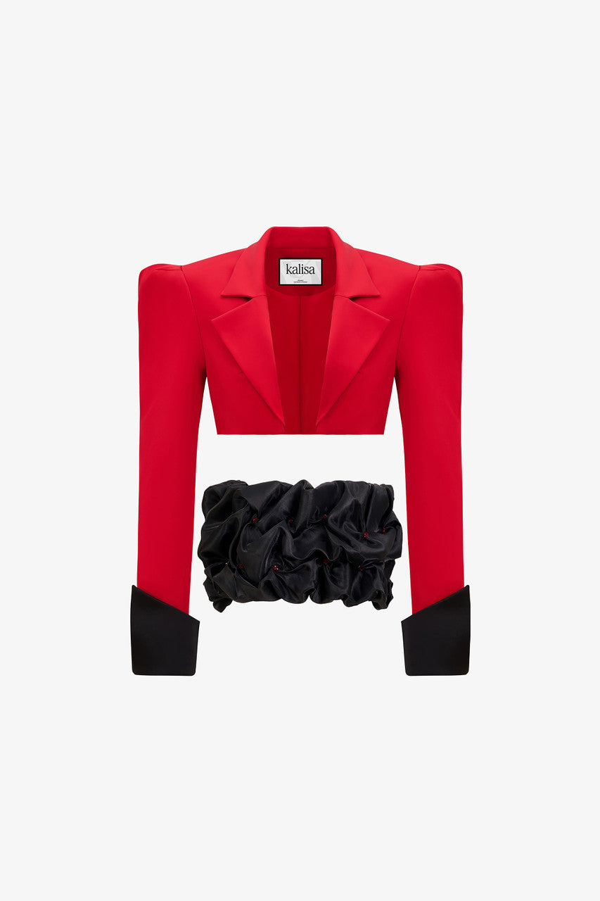 a red crop blazer and a draped black mini skirt with a crystal embellished belt. 
