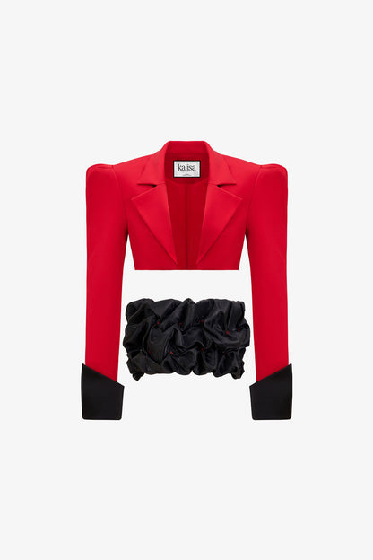 a red crop blazer and a draped black mini skirt with a crystal embellished belt. 
