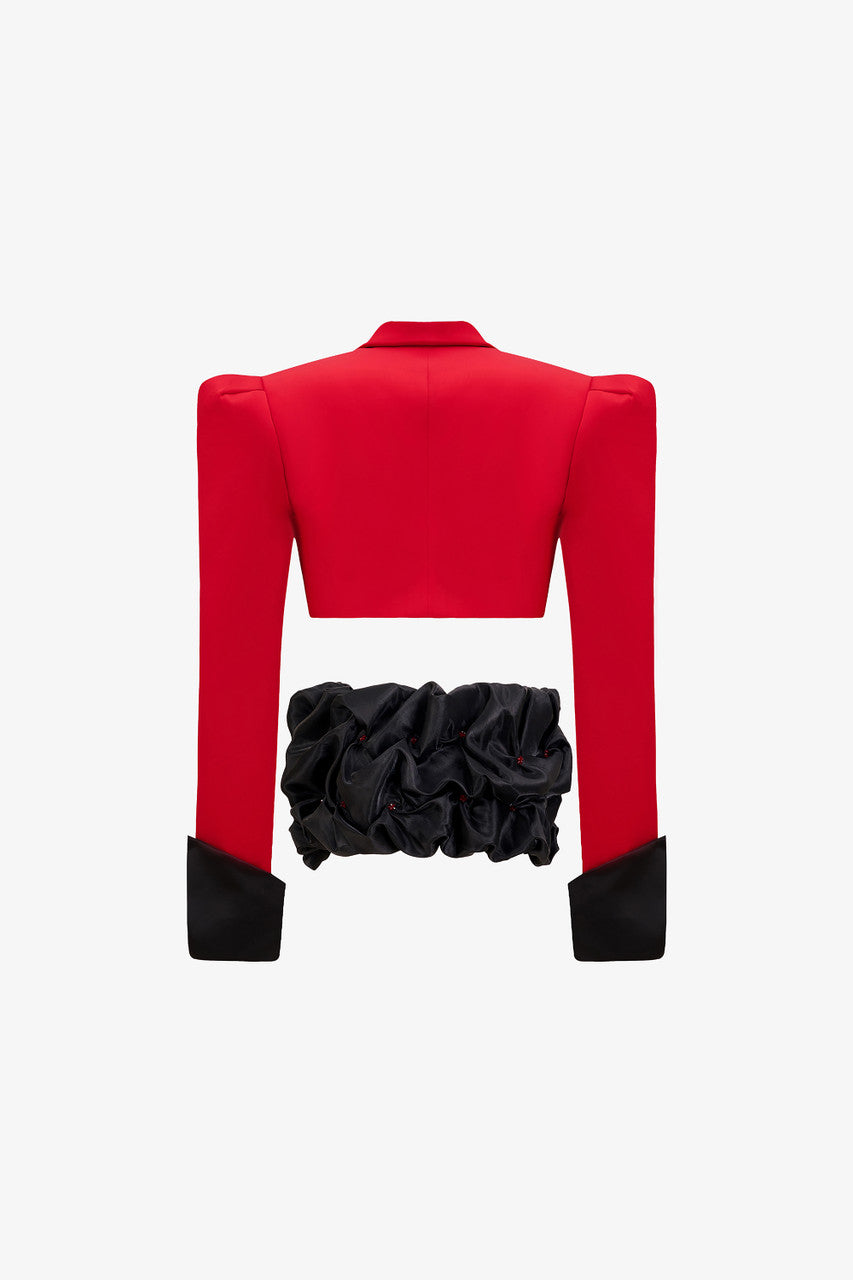 a red crop blazer and a draped black mini skirt with a crystal embellished belt. 
