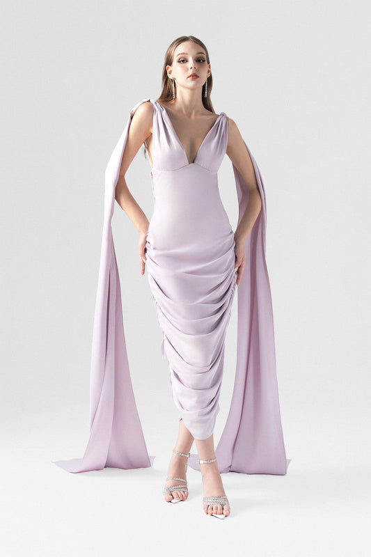 A purple silk dress with V-neckline and two flowing silk flaps. 