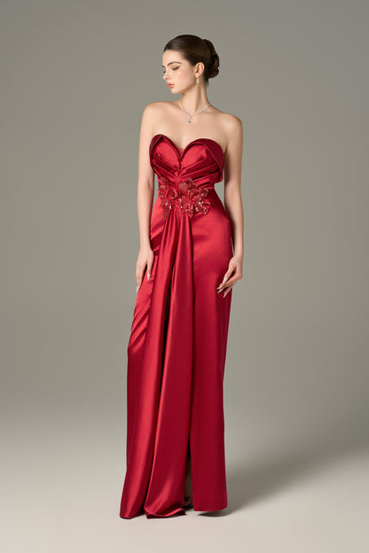 The Red Satin Silk Maxi Dress stuns with a 3D pleated heart bodice, sequin floral details and a  thigh-high slit.
