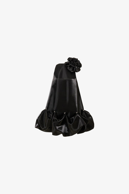 The black mini dress, featuring a oversized floral accent at the neckline and a bubble hem. 