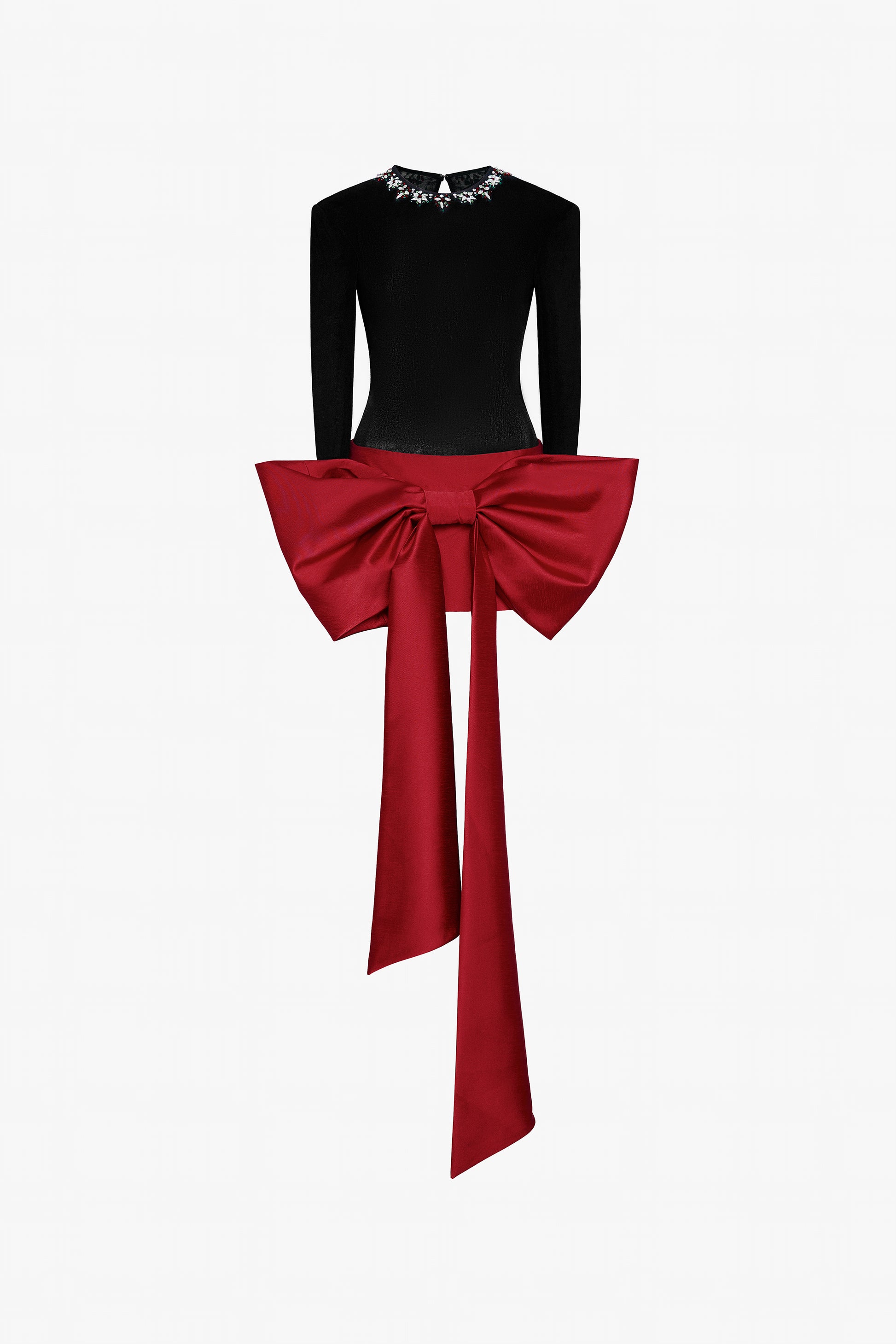 A sleek black fitted top with a beaded round neckline and cut-out back, and a red skirt adorned with an oversized bow. 