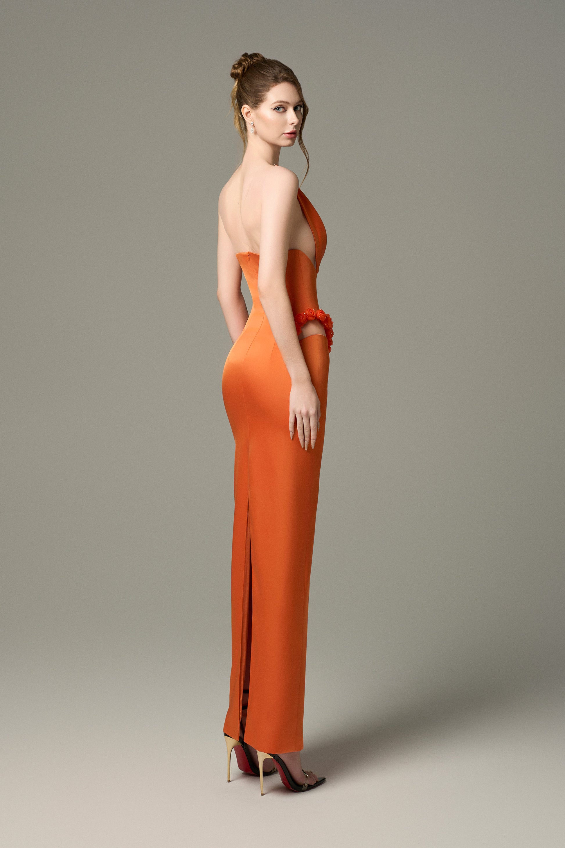 The Elegant Silk Floral Bust Draped Maxi Dress in Orange features a cut-out skirt, a high slit.