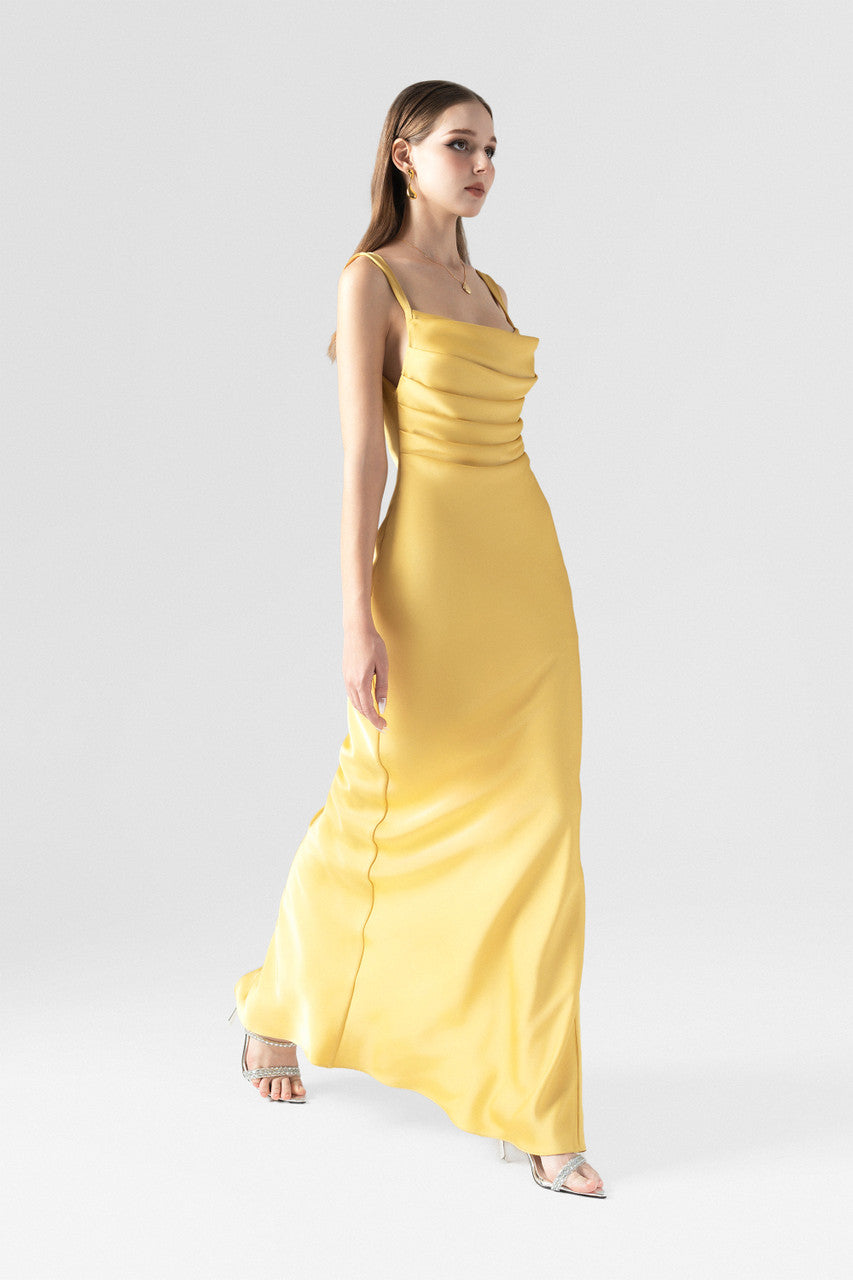 The gold yellow maxi dress, featured cowl neckline with pleats, a side slit and back cutouts. 