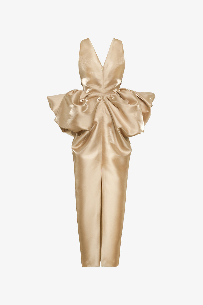 The gold evening dress in silk organza, with a deep neckline, a beaded belt, and exaggerated puffed hips.