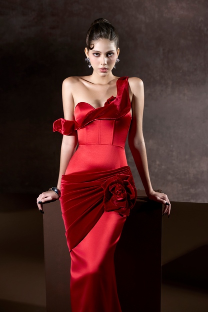 Woman wearing a red evening gown against a dark background