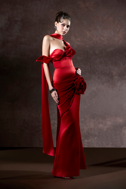Woman wearing a red evening gown against a dark background