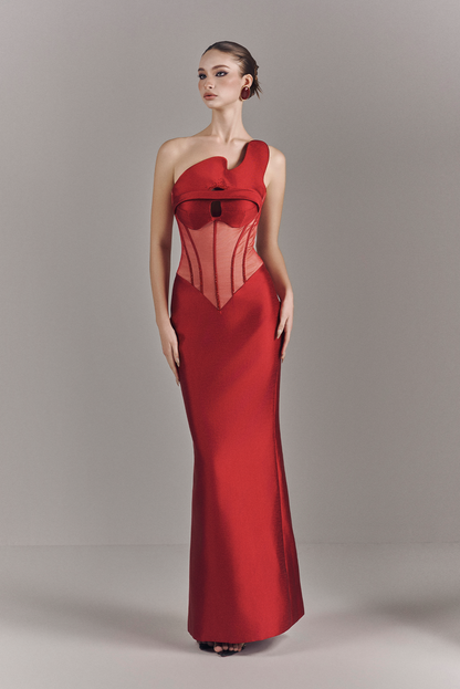 Woman wearing a red evening gown against a neutral background