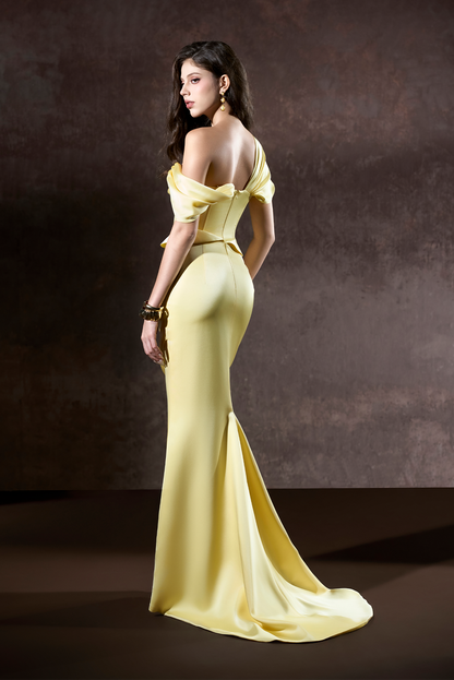 Woman in a yellow evening gown against a dark background