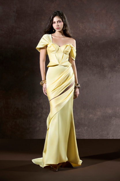 Woman wearing a yellow evening gown against a dark background