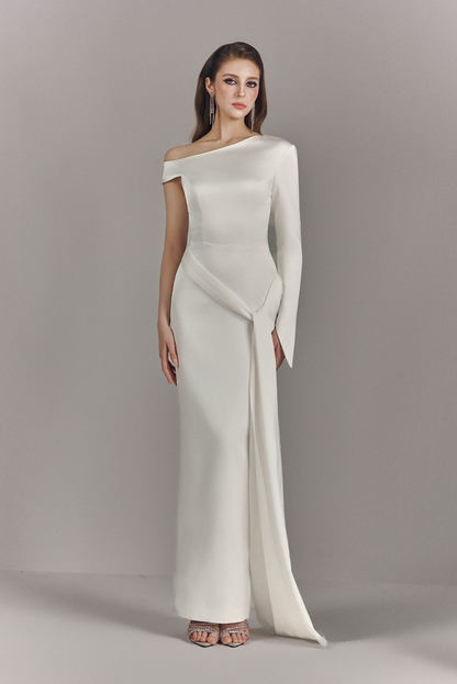Woman wearing a white off-shoulder gown against a gray background