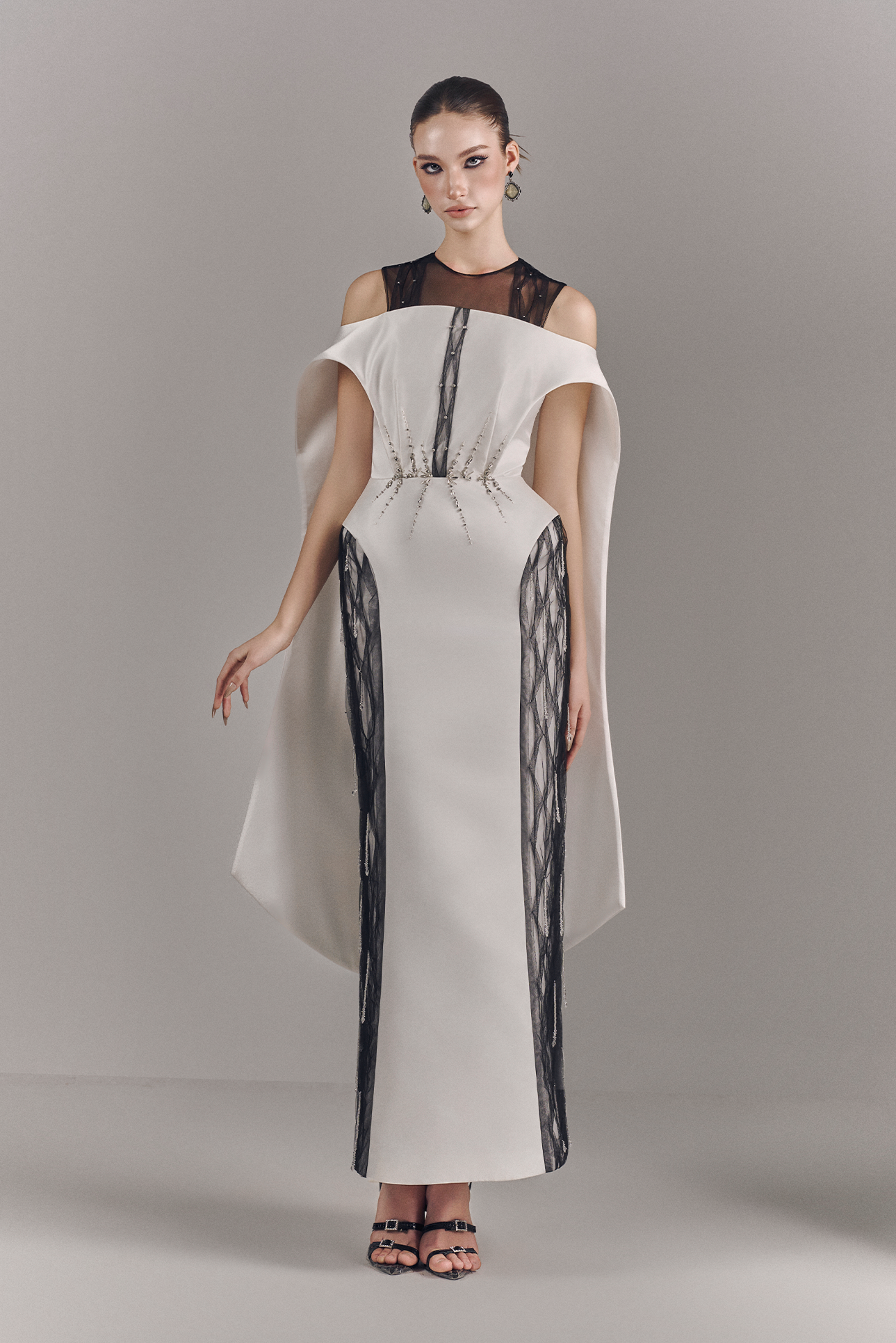 Model wearing a stylish dress with a plain background