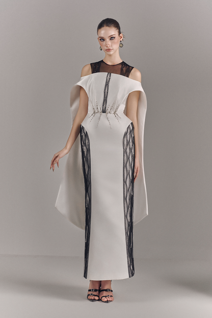 Model wearing a stylish dress with a plain background