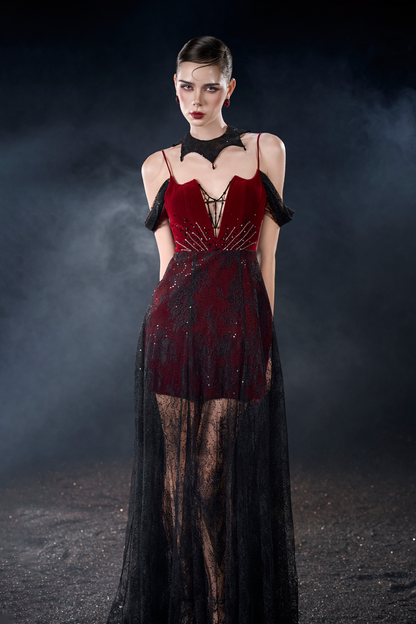 Model wearing a red and black dress with sheer overlay