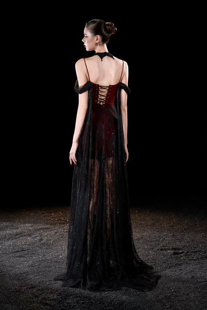 Model wearing a black and red dress with sheer overlay